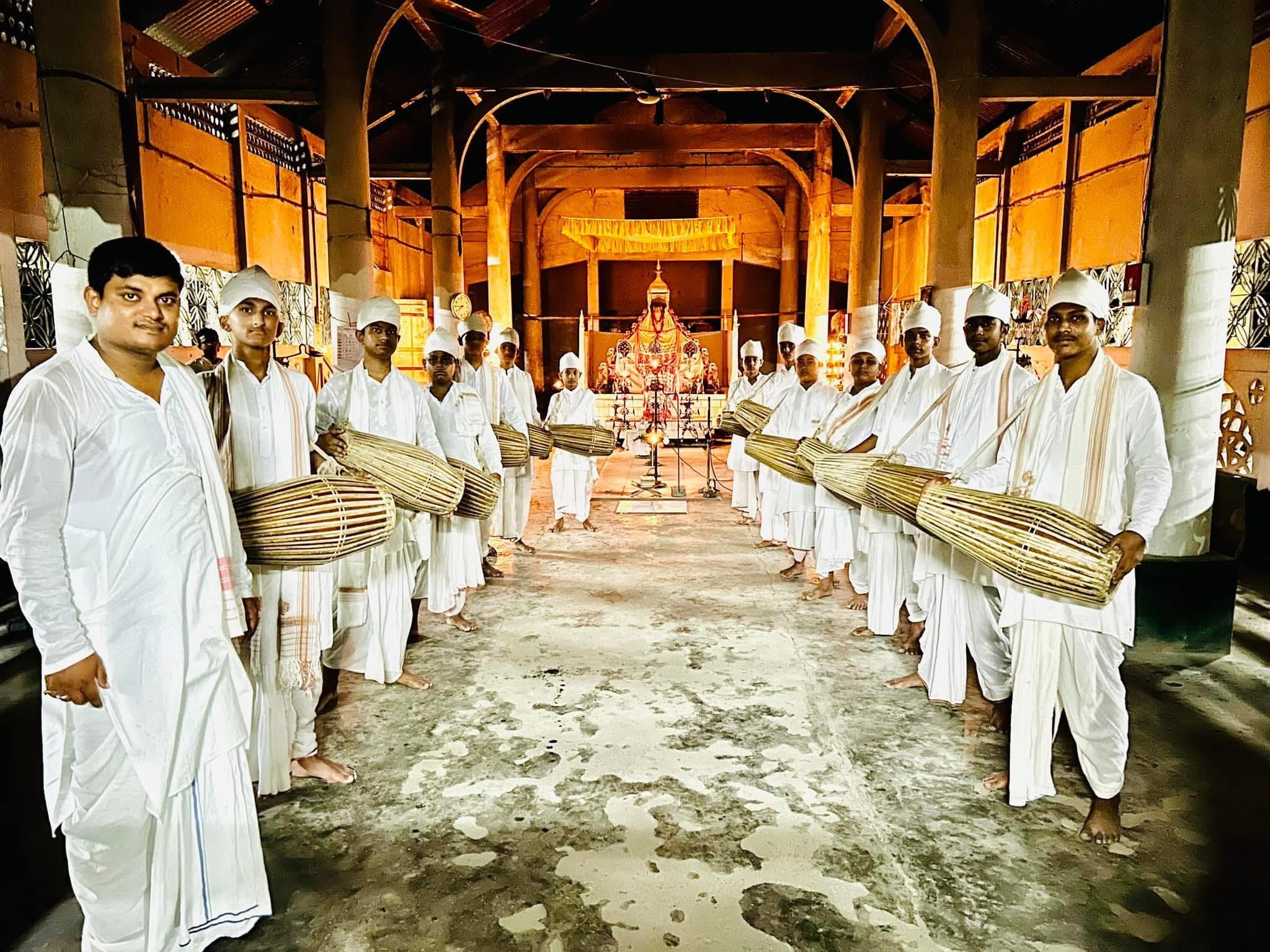 Khol Vadya performers gathered inside a traditional hall